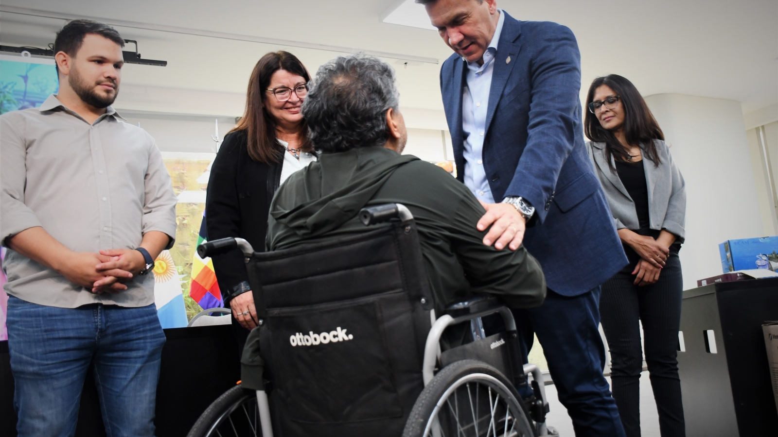 Zdero charlando con una persona en silla de ruedas